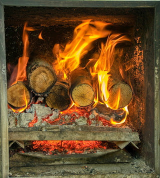 Logs burning brightly in a fireplace